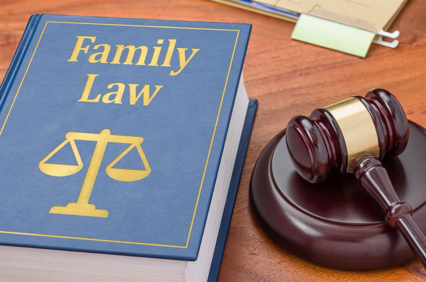 Blue book with "Family Law" title and gavel on a wooden table